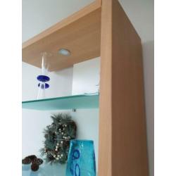 Boekenkast met glasplaten en witte achterwand.