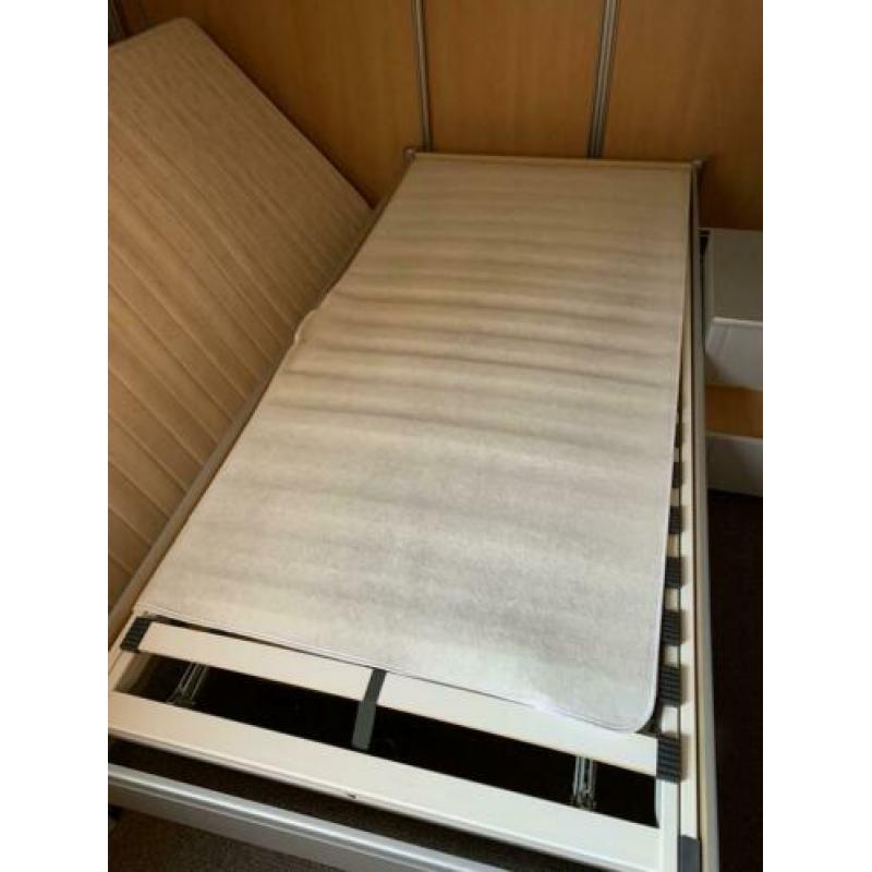 Bed met prima matras en nachtkastje