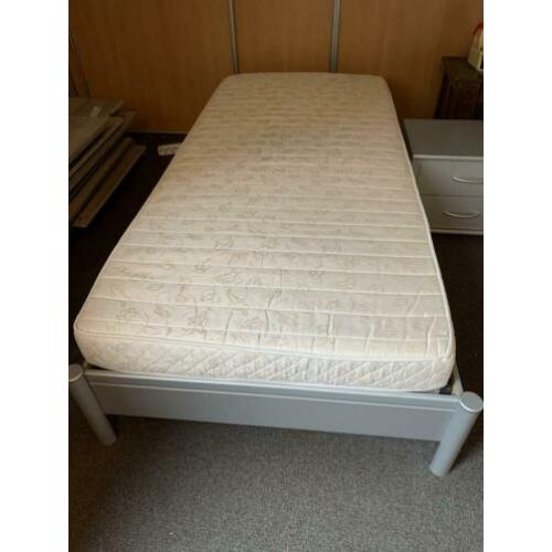 Bed met prima matras en nachtkastje